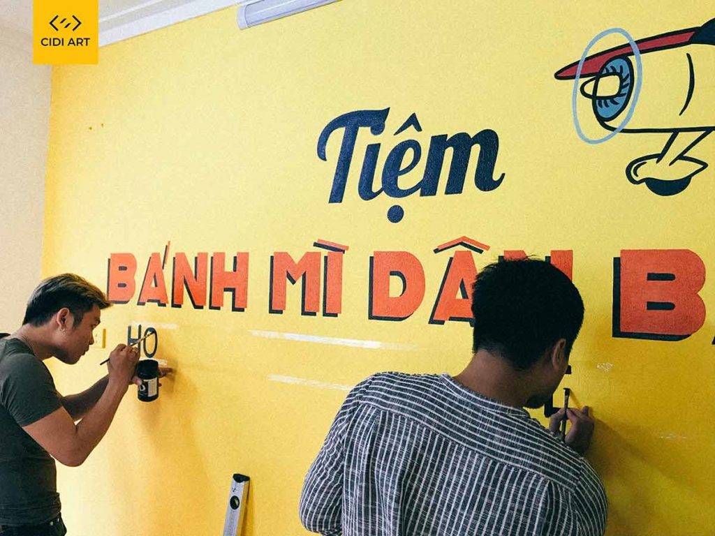 Vẽ tranh tường của hàng bánh mỳ dân bay