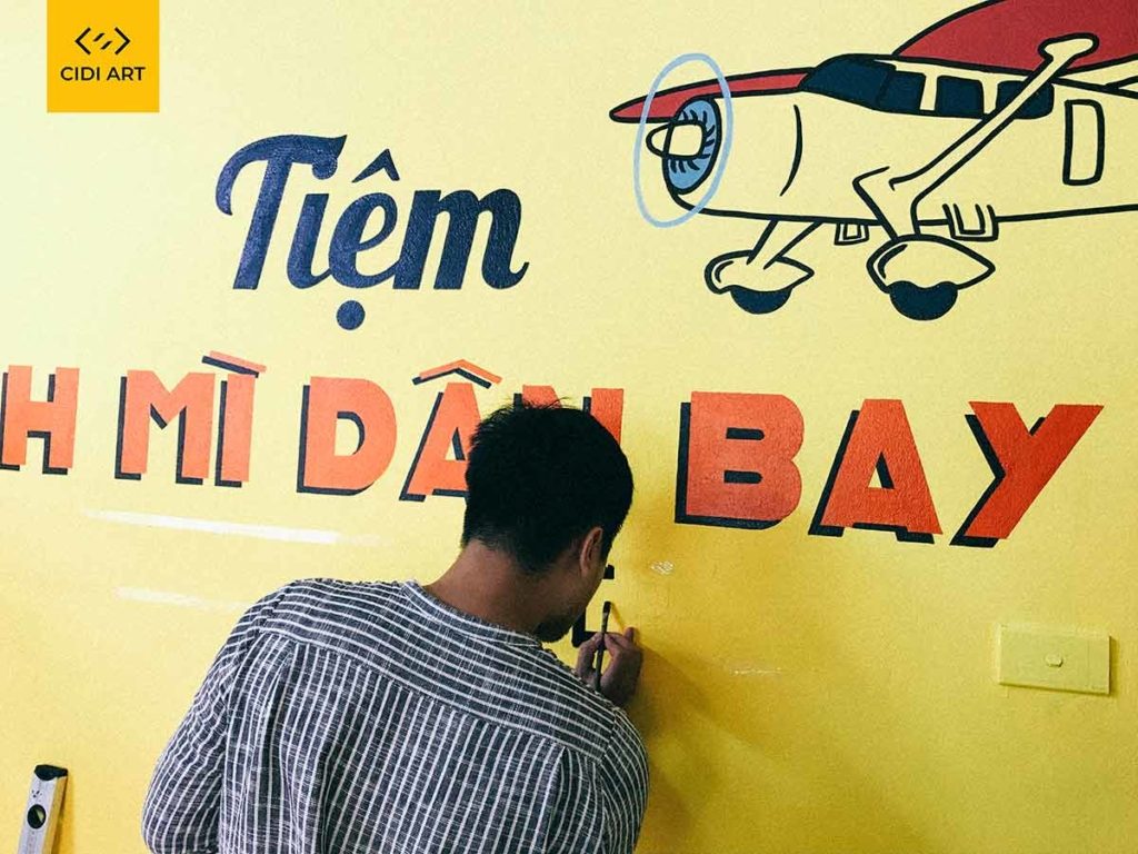 Vẽ tranh tường của hàng bánh mỳ dân bay