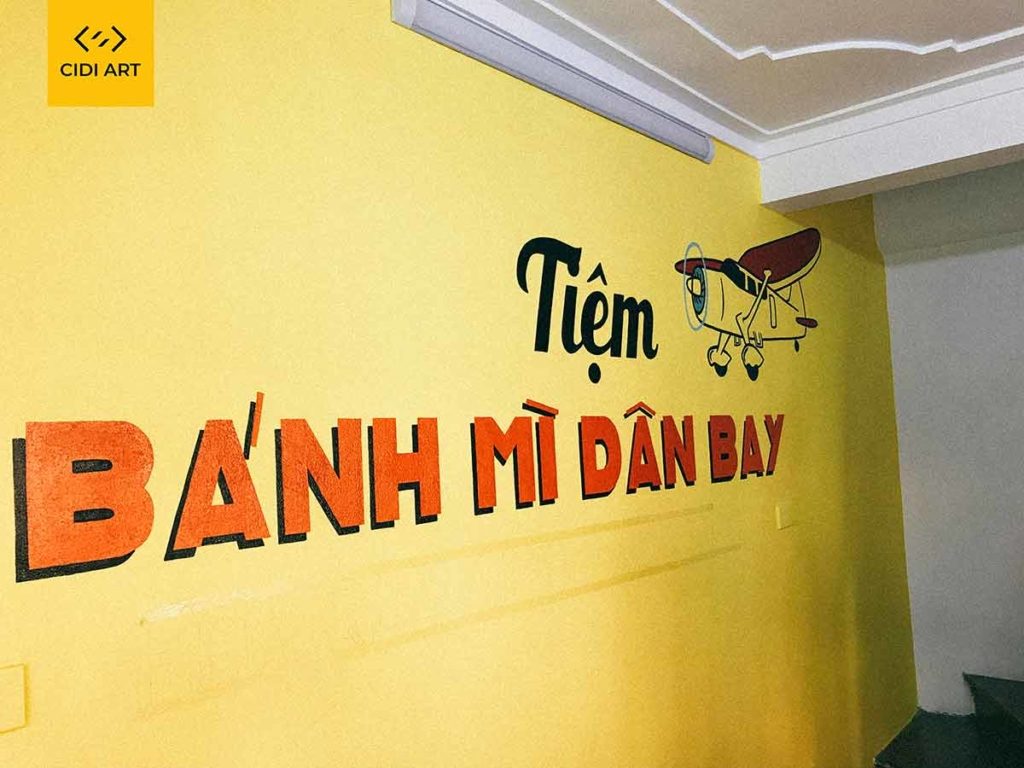 Vẽ tranh tường của hàng bánh mỳ dân bay